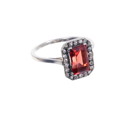 Art Deco spinel and diamond cluster ring with a rectangular step cut orange spinel (not tested for natural origin) surrounded