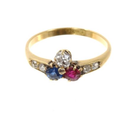 Edwardian diamond, ruby and sapphire ring with a trefoil cluster, further diamonds to the shoulders on 18ct yellow gold shank