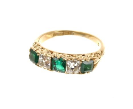 Late Victorian emerald and diamond five stone ring with three square cut emeralds and two square cushion cut diamonds in a ca