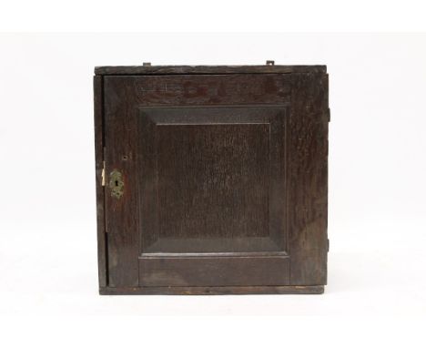 18th century oak spice cupboard with six internal drawers enclosed by fielded panel door with butterfly hinges, 49cm wide x 2