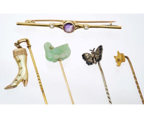 Four antique stick pins – to include a carved green hardstone / jade duck stick pin, together with an Edwardian 15ct gold and