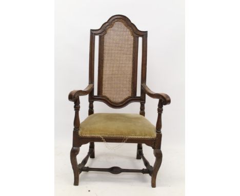 Early 18th century Continental walnut and caned open armchair, arched panel back and scrolling arms, with stuffover upholster