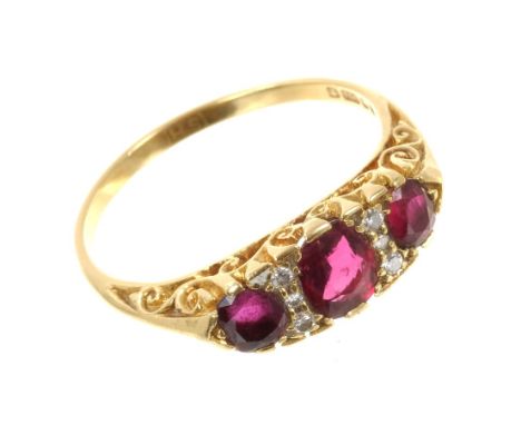 Victorian-style ruby and diamond ring with three oval mixed cut rubies interspaced by six small brilliant cut diamonds in 18c