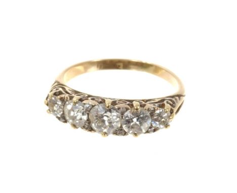 Edwardian diamond five stone ring with five graduated old cut diamonds in carved gold setting with rose cut diamond accents, 