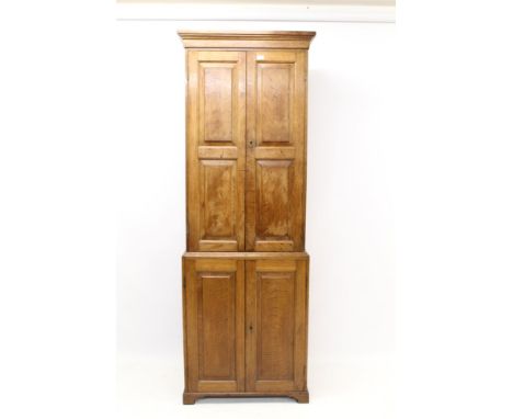 19th century oak two-height cupboard, shelved interior enclosed by two pairs of fielded panel doors, on bracket feet, 74cm wi