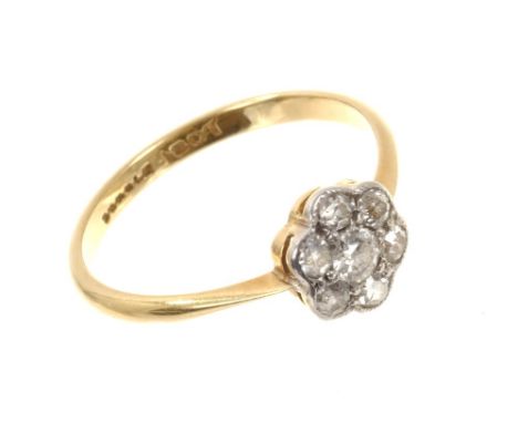 Antique diamond cluster ring with a flower-head cluster of seven old cut diamonds in millegrain setting, on 18ct gold shank. 