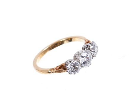 Diamond three stone ring with three old cut diamonds in carved platinum coronet claw setting, carved shoulders on 18ct yellow