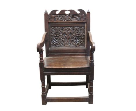 Rare mid-17th century carved oak Wainscott chair, the panel back with fret cresting and relief-carved with narrow frieze of h