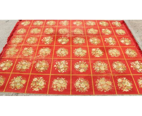 Good antique tapestry carpet, eight rows of six floral panels on red ground with tassel ends, 372 x 287cm 