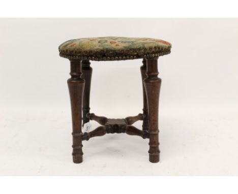 Queen Anne walnut stool, the original petit point tapestry seat on turned legs joined by turned X-frame stretchers, 37cm diam