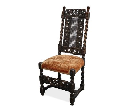 Charles II carved walnut and caned side chair with pierced putto and foliate scroll carved top rail and panel back between ba