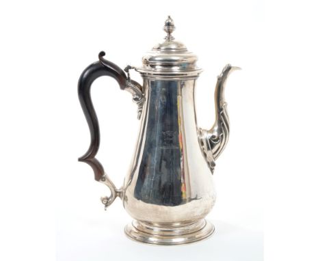 Late George II / early George III silver coffee pot of baluster form with engraved armorial crest, fruitwood scroll handle an