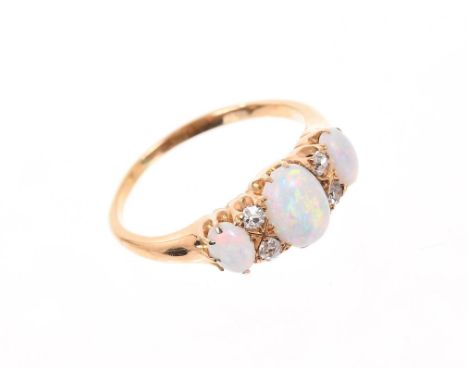 Edwardian opal and diamond ring with three opal cabochons interspaced by four old cut diamonds in 18ct gold setting. Finger s