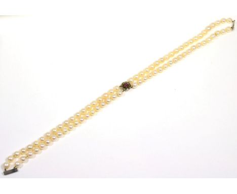 A double strand cultured pearl necklace with a 9 carat white gold ruby cluster clasp, length 38cm The necklace is in good con
