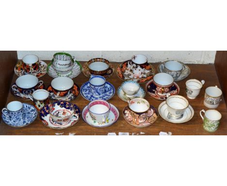 A shelf of cups and saucers including Davenport; Masons and Wedgwood 