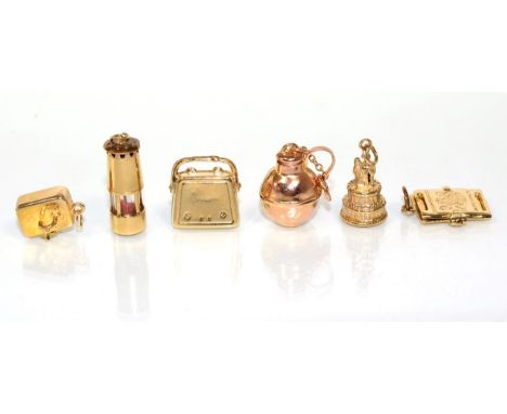 Six various 9 carat gold charms, including; a lamp, a sink, a wedding cake, a handbag, a passport and a kettle 12.9g gross