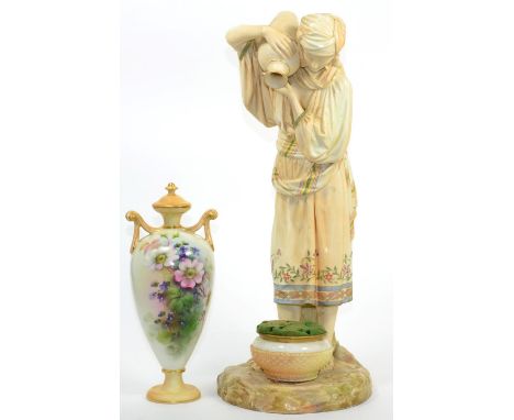 A large Royal Worcester figures of a water carrier; and a Royal Worcester twin handled vase and cover 