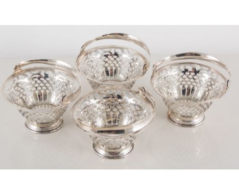 Four silver baskets, pierced bodies with fish scale design and loop handles, Walker & Hall, Birmingham, 1909; together with a