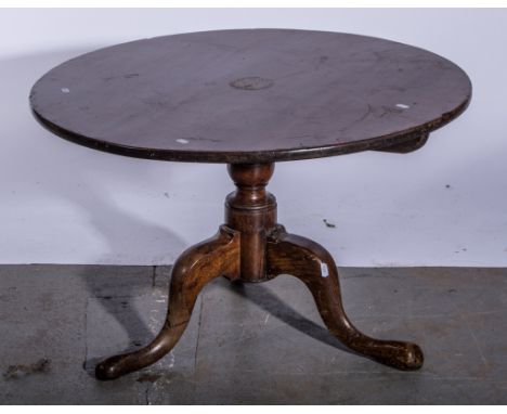 Late Georgian oak occasional table, circular tilt top, with a baluster turned column, tripod legs, the top diameter 77cm, hei