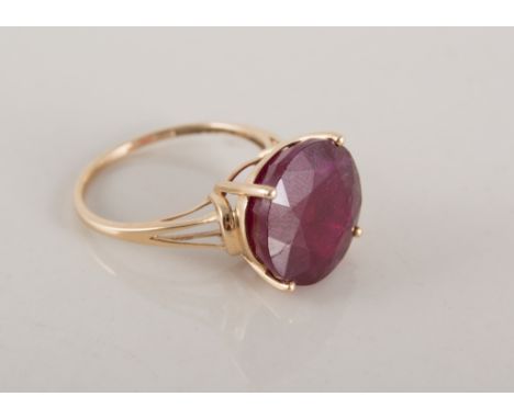 An enhanced ruby dress ring,  the circular faceted stone, 14mm diameter, four claw set in a 9 carat all yellow gold mount, ce