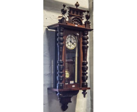 Viennese type wall clock, carved and turned surmount, turned columns, glazed door enclosing white enamel dial, Roman numerals