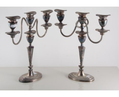 Pair of Edwardian silver-plated three-light table candelabra, neo-classical style, oval bases, height 29cm, together with a f