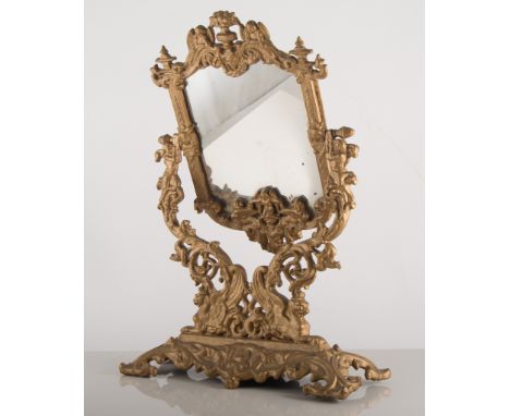 Three gilt wall mirrors, and a gilt metal easel mirror.