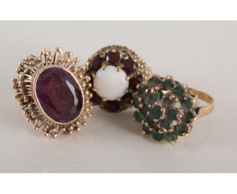 Three dress rings set with semi-precious stones, one hallmarked 9 carat yellow gold, two unmarked yellow metal, emerald clust