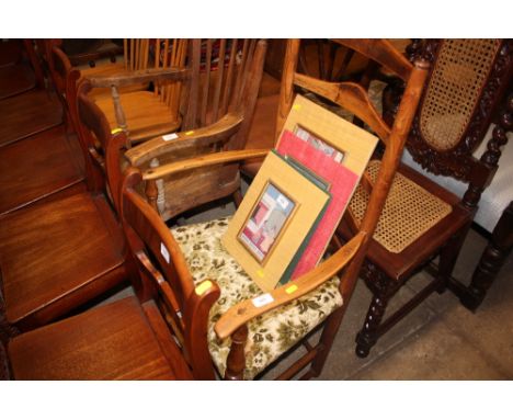 A 19th Century oak ladder back elbow chair with green floral upholstery