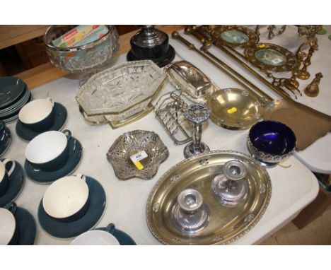 A silver plated trophy cup; together with a silver plated toast rack; a glass pedestal bowl; pair of candlesticks etc.