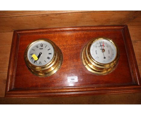 A ship's brass cased clock and barometer set mounted on mahogany frame 