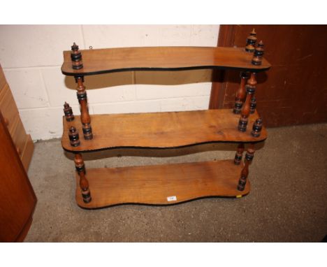 A wooden three tier wall shelf 