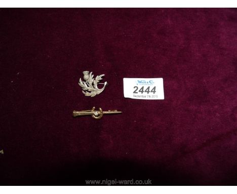 A 9ct gold bar brooch of hunting symbolism having a farriers nail bar set with a small simulated diamond within a horse shoe;