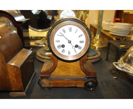 A walnut cased two hole balloon mantel clock