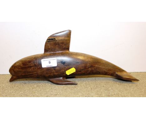 A carved hardwood sculpture of a dolphin