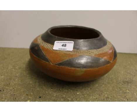 A vintage Native American earthen ware bowl with geometric decoration