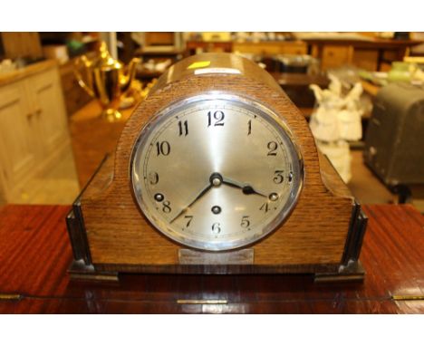 A 1930's oak cased three hole mantel clock with presentation inscription