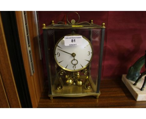 A brass and glass anniversary clock