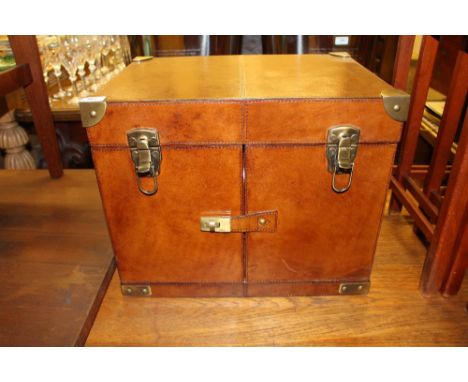 A leather and plate mounted picnic hamper