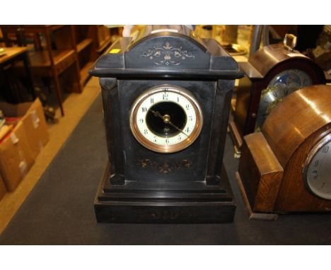 A late Victorian black slate single hole mantel clock 