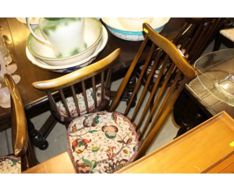 A set of four Ercol stick back kitchen chairs; together with an oak drop leaf table 