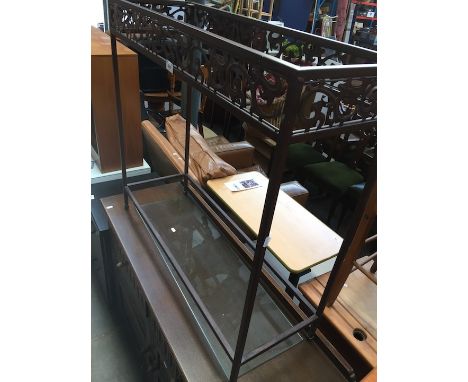 A glass top metal console table. 