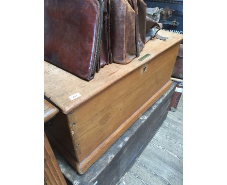 A pine trunk of dovetailed construction with brass handles, width 94cm, depth 49cm &amp; height 44cm. 