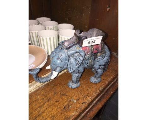 A cast iron money box / door stopper in the form of an elephant. 