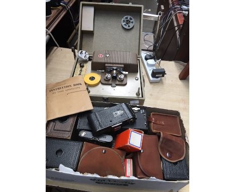 A box of vintage cameras Kodak, Ilfomatic, etc and a projector. 