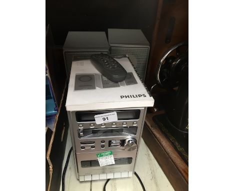 A Philips micro hi-fi system with pair of speakers, remote and manual. 