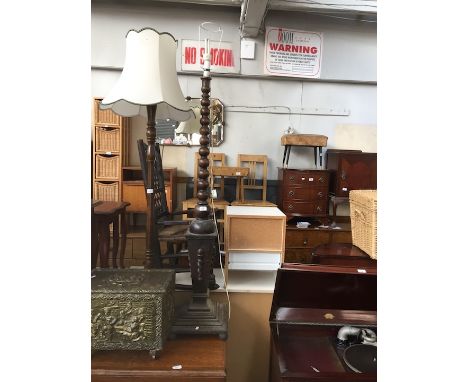 A oak standard lamp bobbin turned top on platform base. 