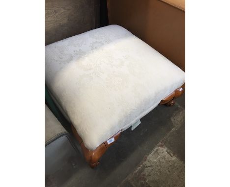 A cabriole leg cream upholstered pouffe. 