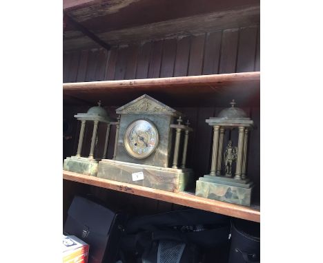 A 19th century onyx mantle clock with garniture. 