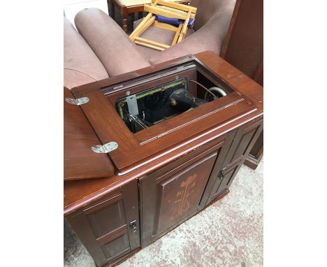 A Bradbury &amp; Co inlaid cabinet sewing machine with inlaid door. 